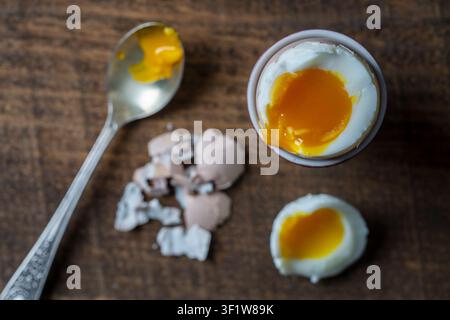 Soft boiled egg on a wooden table, top view. Traditional food for healthy breakfast. Close-up shot. Stock Photo