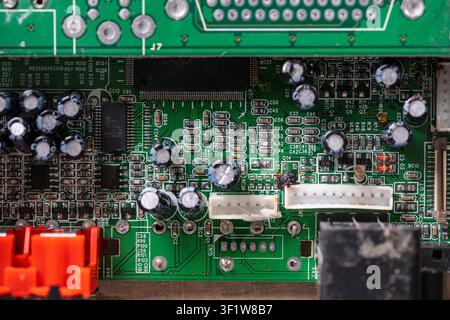 Old printed circuit board background. Vintage circuit board with soldering trace, close up, top view. Backside brown electronic chip retro style desig Stock Photo