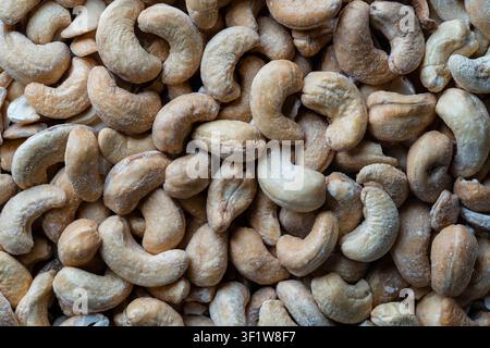 Pile cashew nuts without shell, close up, top view. Whole nut kernels Stock Photo