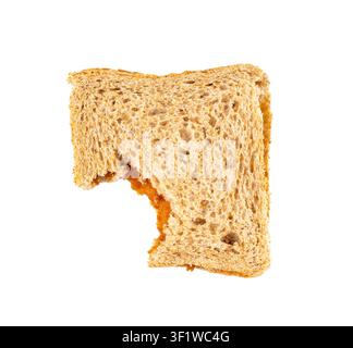 Bitten dried pate sandwich isolated, low-quality food leftovers, bad quality old toast bread, taste bad peanut butter lunch on white background top vi Stock Photo