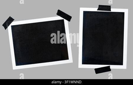 set of two blank instant photo frame with black tape cut out on gray background Stock Photo