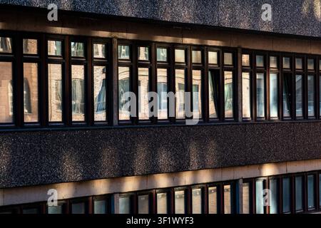 Golden Sun Reflection in Window of Modern Minimalist Architecture Facade Stock Photo