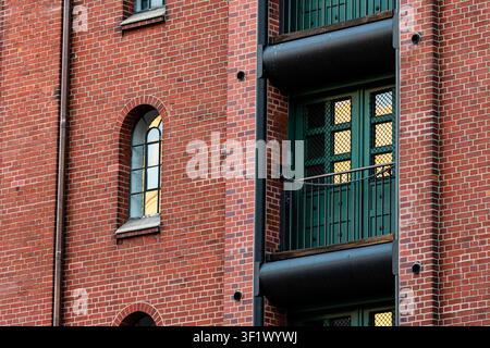 Arched Window on Red Brick Wall Reflecting Golden Sunset Light Stock Photo