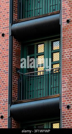 Arched Window on Red Brick Wall Reflecting Golden Sunset Light Stock Photo