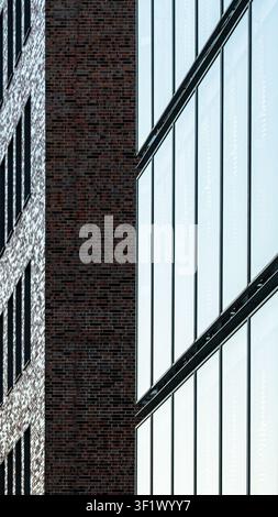 Modern Vertical Architecture Abstract with Glass Facade and Red Brick Wall Stock Photo