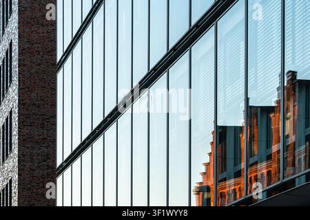 Modern Glass Facade Reflecting Historic Red Brick Building Architecture Stock Photo