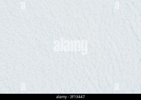 Horizontal close up of a soft fluffy white sherpa fleece textile texture showing cozy delicate plush fibers on a warm blanket or winter clothing surfa Stock Photo