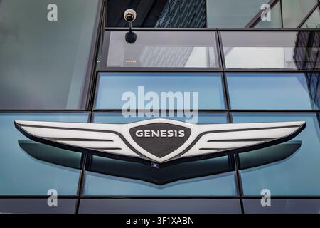 The Genesis winged emblem displayed on the glass facade of the luxury car brand's showroom in New York City Stock Photo