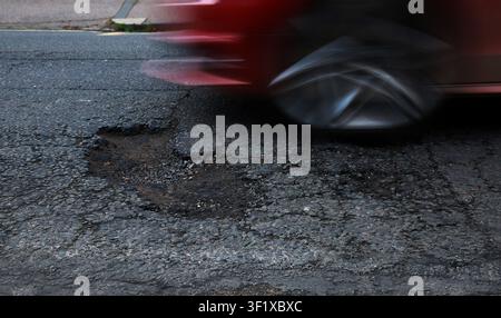 A pothole with moving car Stock Photo