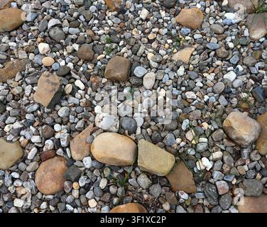 Horizontal close up of assorted color landscape rocks with mixed sizes and shapes, porous uneven broken stones Stock Photo