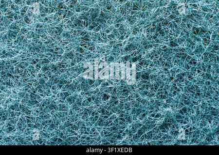 The image is a close-up, full-frame shot of a blue fibrous material. The fibers are thin, tangled, and create a dense, textured surface. Stock Photo