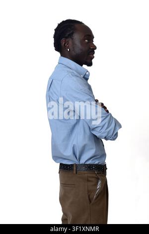 side view of  waist up portrait of a african man arms crossed Stock Photo