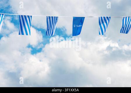 Tallinn, Estonia, August 31, 2024. Tallinn city flags and logo bunting against cloudy sky in Estonia Stock Photo