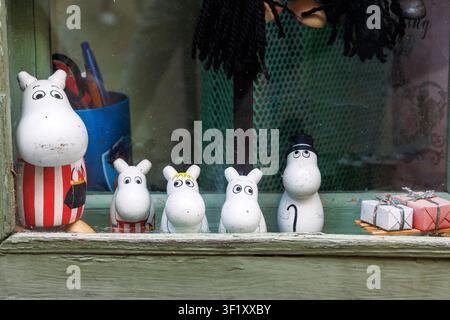 Tallinn, Estonia, August 31, 2024. Moomin character figurines and collectible decorations displayed in a souvenir shop window. Stock Photo