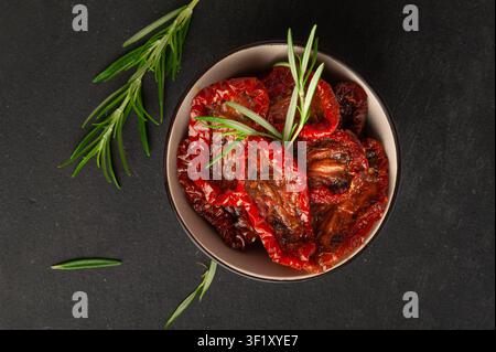 Dry Tomatoes in Bowl, Sun Dried Pomodoro Pile, Dehydrated Tomato In Olive Oil, Cured Sundried Vegetable Slices, Dry Plum Tomatoes, Italian Snack on Bl Stock Photo