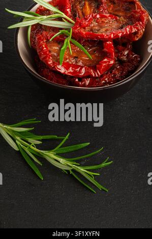Dry Tomatoes in Bowl, Sun Dried Pomodoro Pile, Dehydrated Tomato In Olive Oil, Cured Sundried Vegetable Slices, Dry Plum Tomatoes, Italian Snack on Bl Stock Photo