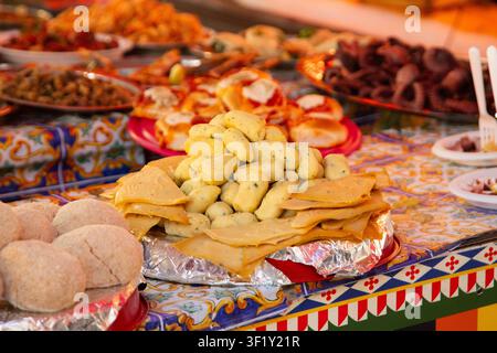 Ballaro Market Palermo street food stall with wine and assorted sicilian street food. Stock Photo