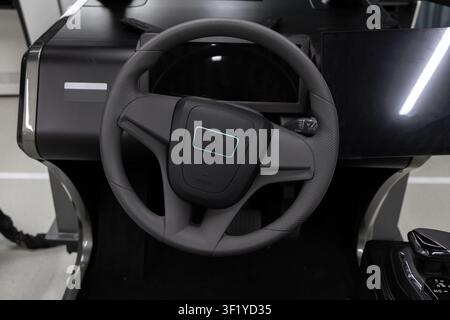 Steering wheel of a modern car simulator system featuring digital dashboard and touchscreen displays with a joystick control, conveying advanced autom Stock Photo