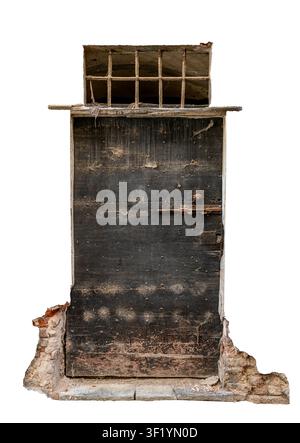 old, and weathered dark wooden door featuring metal studs, a rusty latch lock, a small barred window on top, and fragments of a crumbling ancient bric Stock Photo