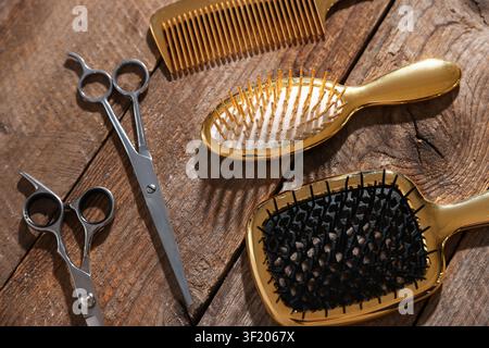 Different hairdresser's tools on wooden table, closeup Stock Photo