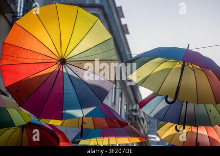 Lisboa, Portugal - 09 July 2026: View of the iconic colorful umbrellas suspended above Pink Street, creating a vibrant canopy against the historic bui Stock Photo
