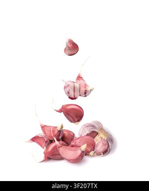 Falling Garlic Cloves Isolated, Flying Garlic Clove Group, Seasoning Bulb, Natural Spices Food Ingredient on White Background Stock Photo