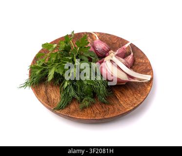 Young Garlic Cloves on Wood Plate Isolated, Garlic Clove Group, Seasoning Bulb, Natural Spices Food Ingredient with Green Parsley and Dill on White Ba Stock Photo
