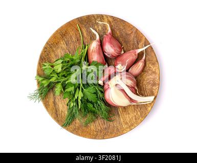 Young Garlic Cloves on Wood Plate Isolated, Garlic Clove Group, Seasoning Bulb, Natural Spices Food Ingredient with Green Parsley and Dill on White Ba Stock Photo