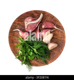 Young Garlic Cloves on Wood Plate Isolated, Garlic Clove Group, Seasoning Bulb, Natural Spices Food Ingredient with Green Parsley and Dill on White Ba Stock Photo