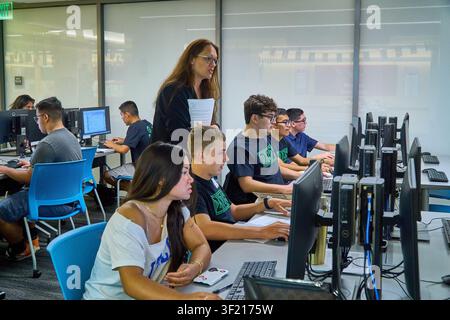Palm Desert, California, USA. 14th July, 2026. Dana Sanchez of Coachella Valley High School works with students during the Air & Space Forces Association Palm Springs Chapter 134 Summer Cyber Camp at the College of the Desert Information Technology Center. The week-long program introduces high school students to cybersecurity, computer networking, coding, artificial intelligence, and cyber defense through hands-on instruction from educators, industry professionals, and AFA volunteers. (Credit Image: © Ian L. Sitren/ZUMA Press Wire) EDITORIAL USAGE ONLY! Not for Commercial USAGE! Stock Photo