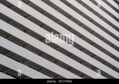 Concrete beams form diagonal stripes across the image. Structural lines create a strong geometric pattern. Modern architecture showcases clean, repeti Stock Photo