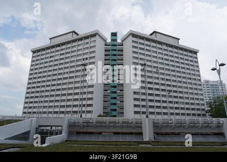 Modern high-rise apartment buildings under partly cloudy sky. Structural design features clean, repeating window patterns. Facade presents uniform, li Stock Photo
