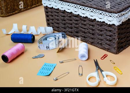 Sewing Supplies and Tailoring Tools Arranged on Workspace Table Stock Photo
