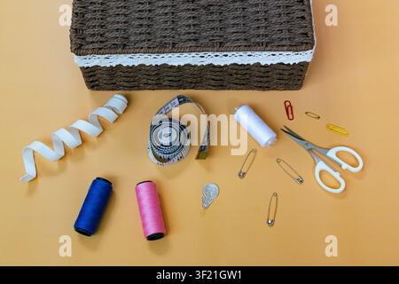 Sewing Supplies and Tailoring Tools Arranged on Workspace Table Stock Photo