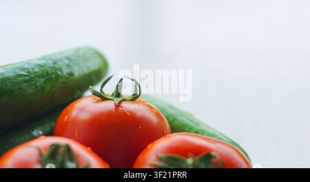 Cucumbers and tomatoes on a white background Stock Photo