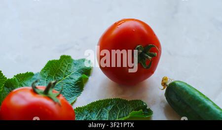 Cucumbers and tomatoes on a white background Stock Photo