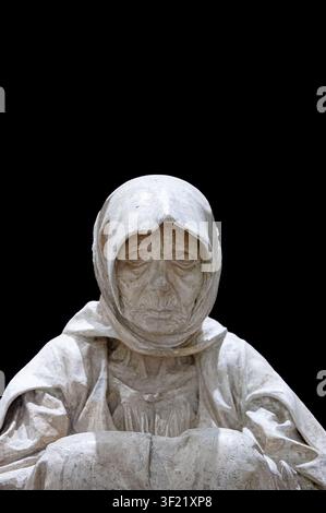 Marble sculpture of a hooded figure on a dark background Stock Photo