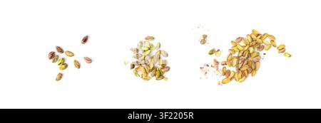 Fried salt pistachio nuts pieces pile isolated. Baked broken pistachios grains, crumbled roasted green pistache fruits and chopped kernels on white ba Stock Photo