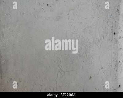 texture of a gray concrete surface. It clearly displays fine pores, unevenness, roughness, and a fine network of hairline cracks. Stock Photo