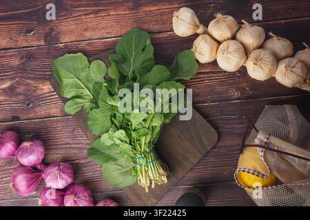 Fresh vegetables on a wooden surface in a kitchen Stock Photo
