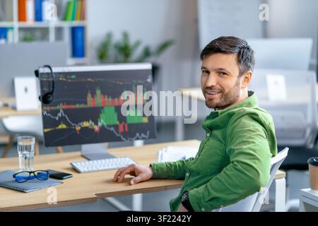 Focused Caucasian Male Trader Analyzing Stock Market Data At Office, Business Concept Stock Photo