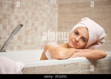 Woman relaxing in bubble bath at spa Stock Photo