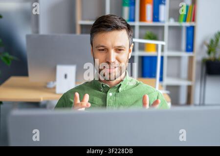 Happy Male Caucasian Professional Smiling While Working On Computer In Office, Business Concept Stock Photo