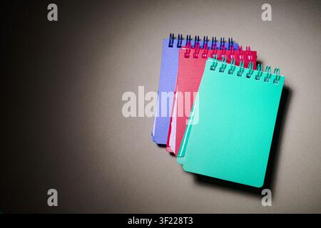 Close-up of small spiral notebooks on a desk. Writing for taking notes and not forgetting anything at school. Stock Photo