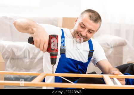Happy Craftsman Working Using Drill Tool Fixing Wooden Cabinet Indoor Stock Photo