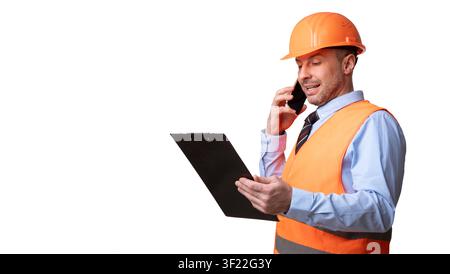 Builder In Uniform Talking On Phone Standing On White Background Stock Photo