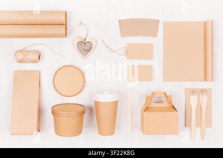 Set of cardboard package for different fast food for advertising, menu, banding identity - card, label, cup, box, packet, cutlery, heart on white wooden background. Stock Photo
