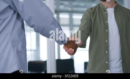 Cropped view two multinational business men shaking hands at office meeting interview boardroom conference international cooperation unrecognizable Stock Photo