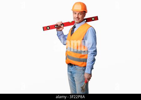 Worker Man Posing With Builder's Level Standing In Studio Stock Photo
