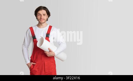 Construction Industry Employee. Young Engineer With Renovation Plan Draft In Hands Stock Photo